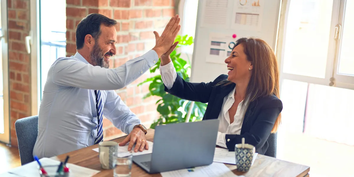 business man and woman giving high five