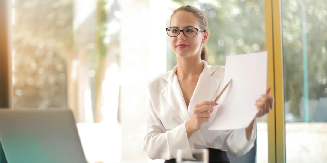 business woman pointing at a sheet of paper