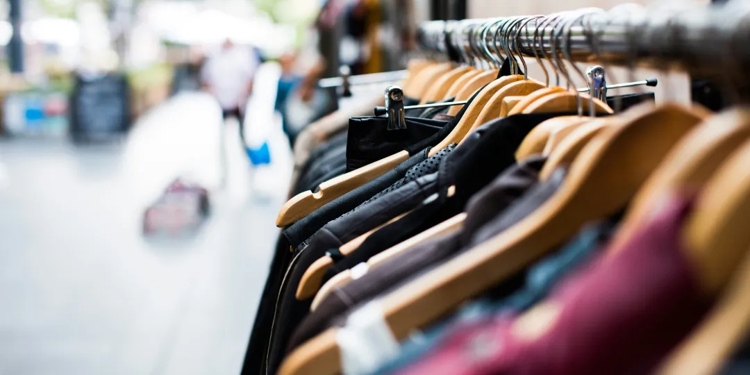 clothes hanging on a rack in a store