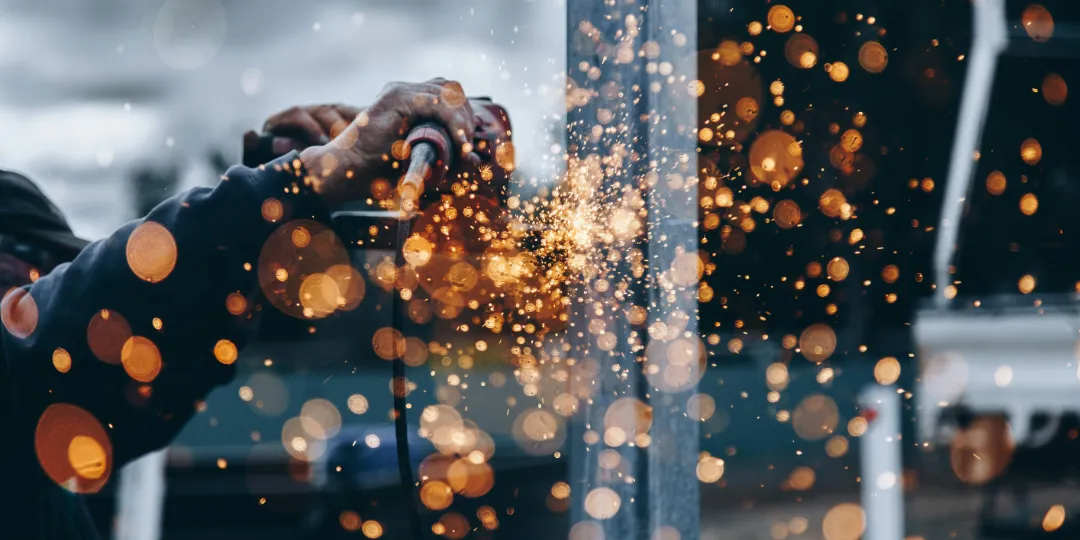 construction worker grinding metal