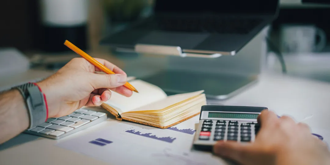 desk with notebook pencil calculator