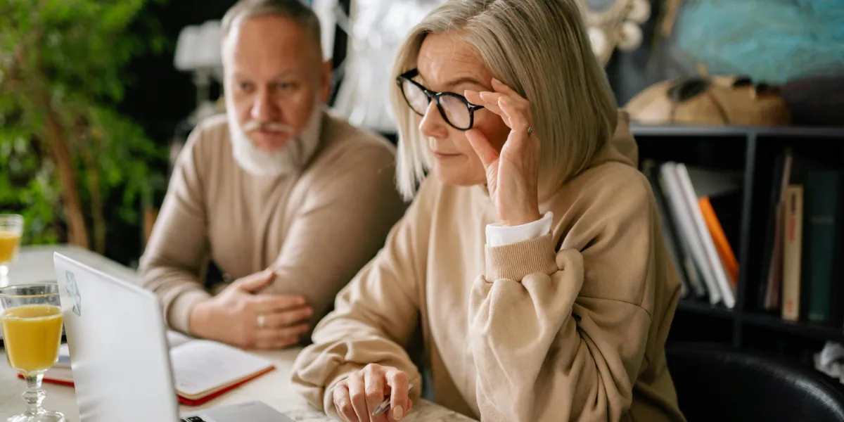 elderly couple looking at computer