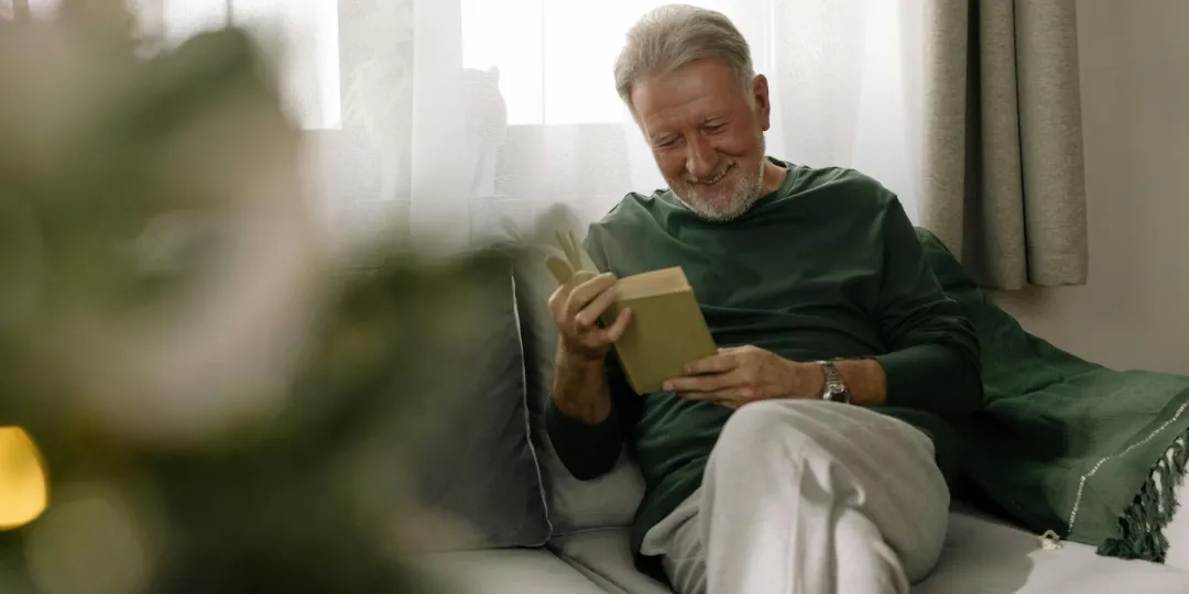 elderly man reading a book