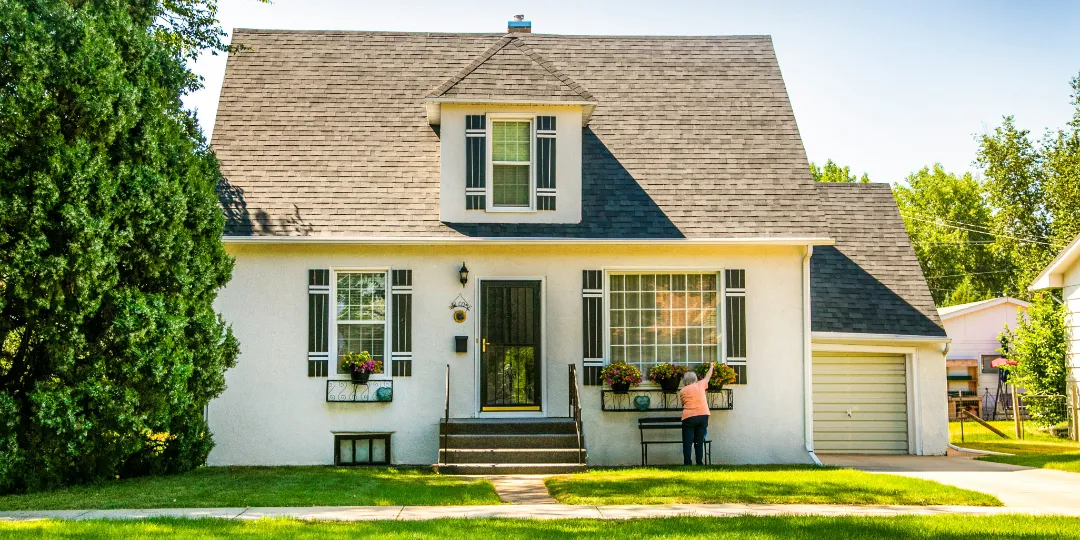 family home with woman in front