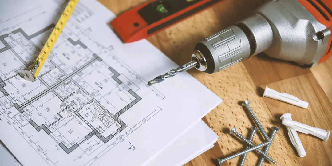 house plan and construction tools on table