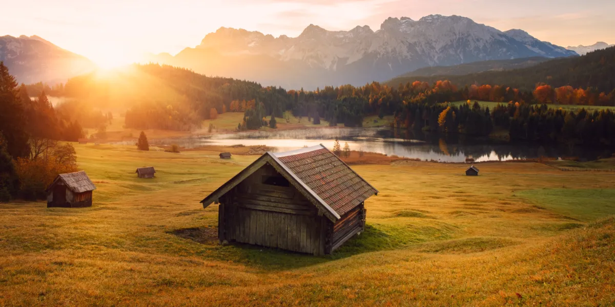 old shed on a field overlooking a lake