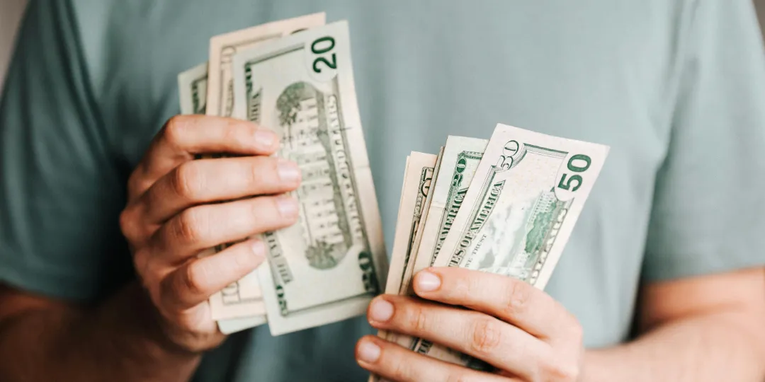 person counting money in hand