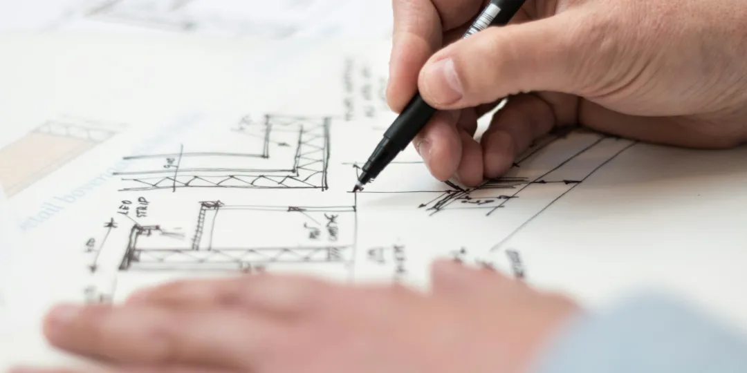 person drawing up contruction plan