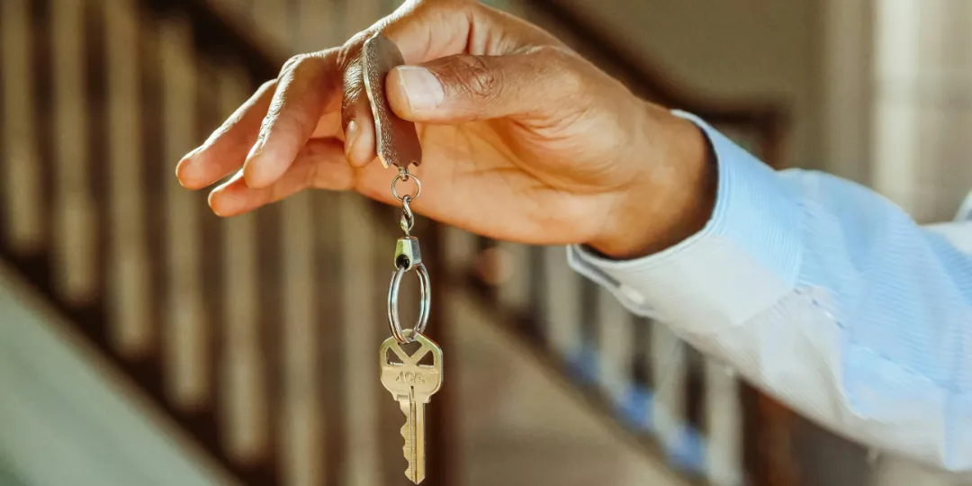 person holding a house key