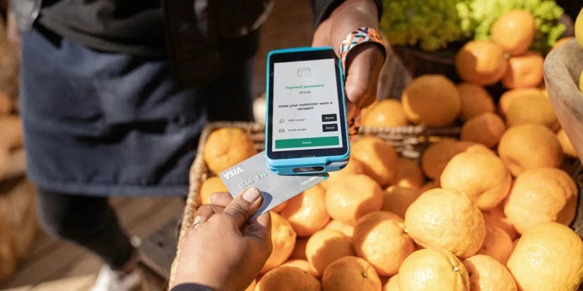 person paying groceries with credit card