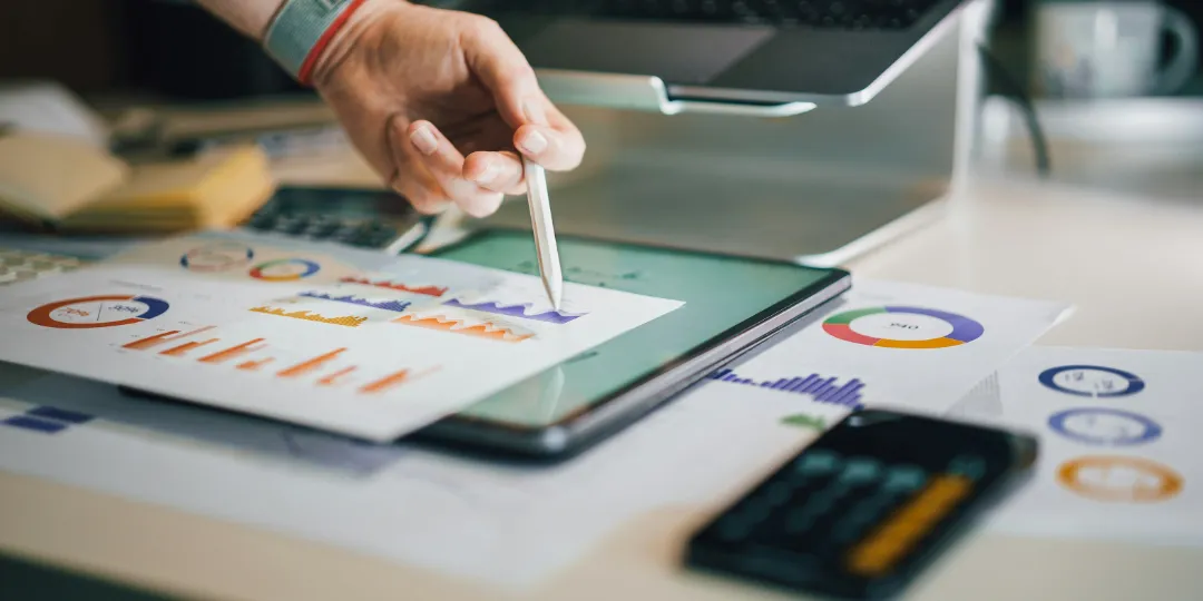 person pointing at chart on desk