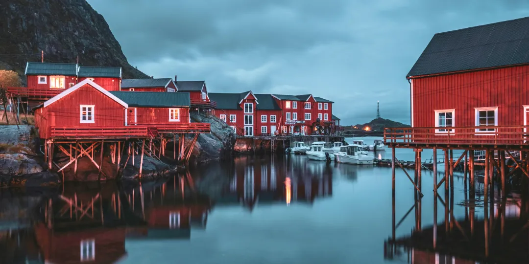 red scandinavian houses on stilts