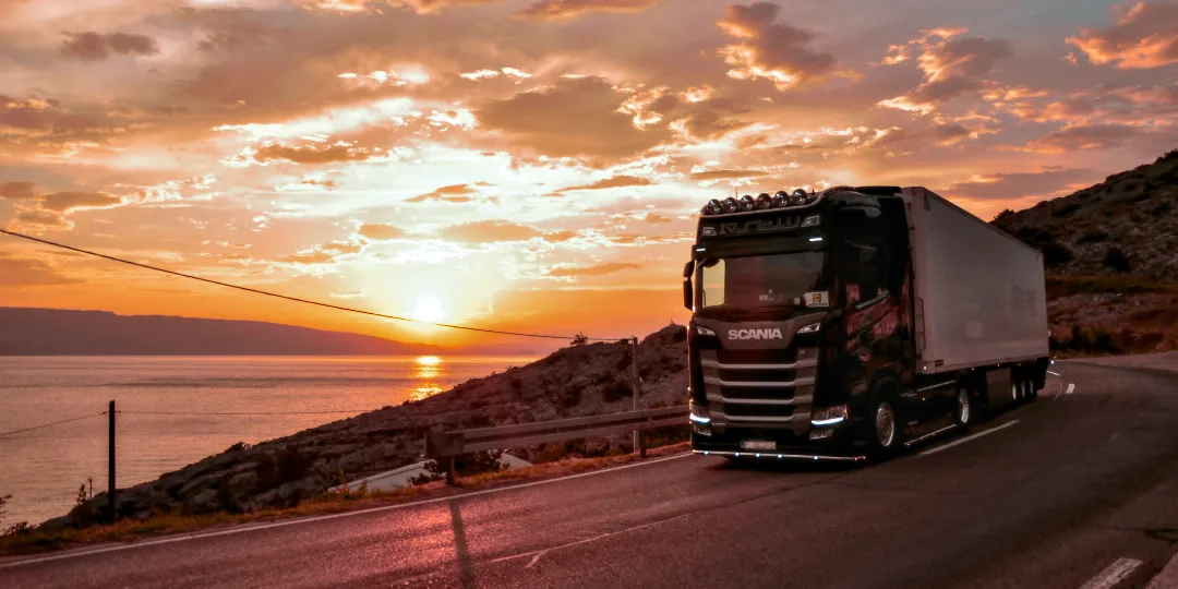 semi truck on road during sunset