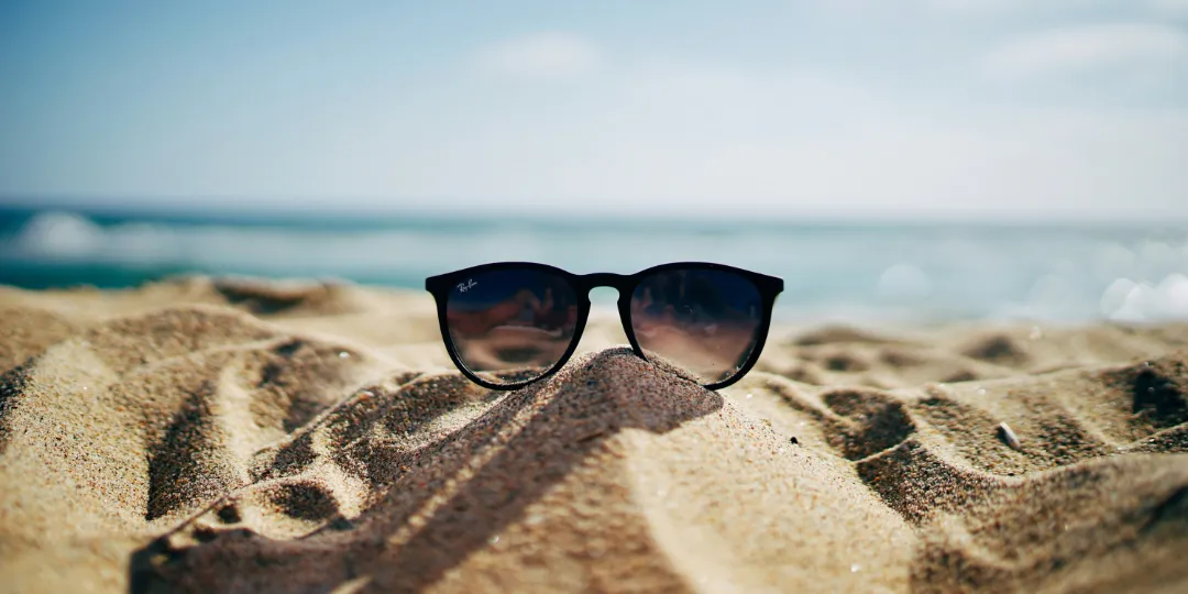 sunglasses laying on beach sand