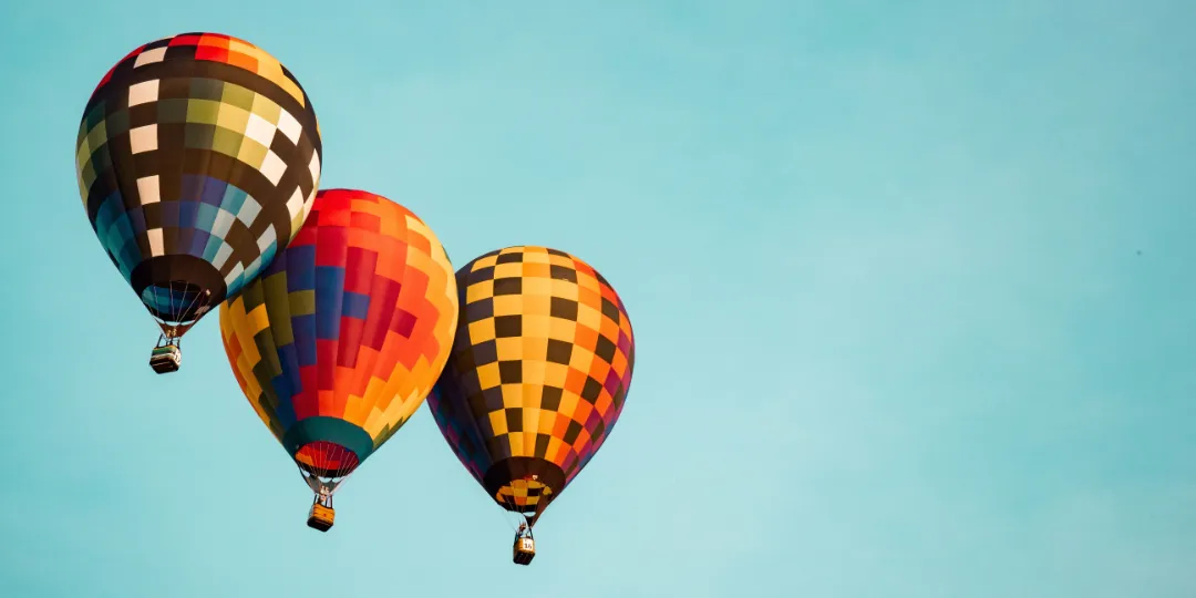 three hot air balloons in the sky