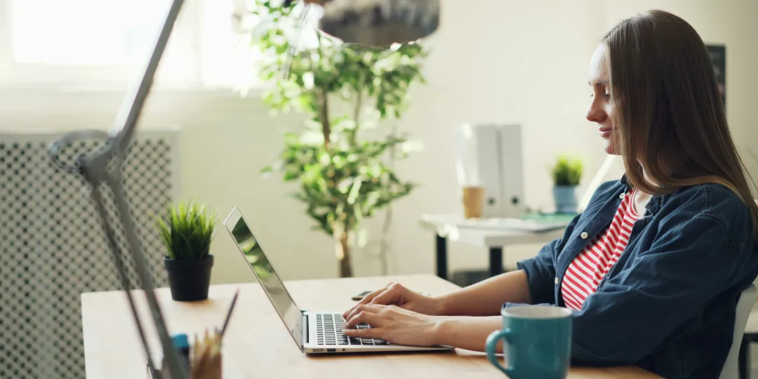 woman at desk typing on computer