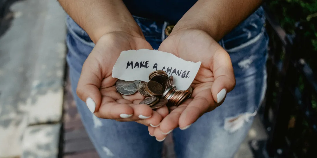 woman holding coins as a donation