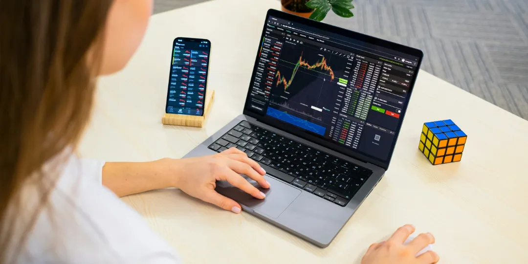 woman looking at investments on computer