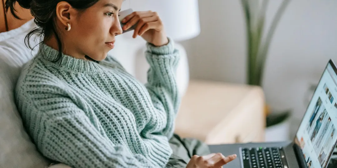 woman looking at website on computer