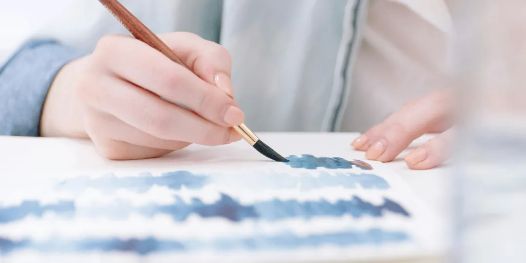 woman painting with watercolor