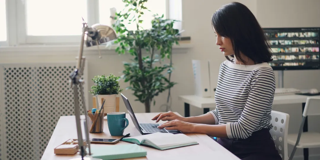 woman sitting at desk in front of computer