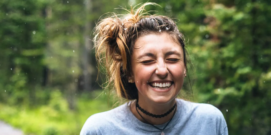 woman smiling in the woods