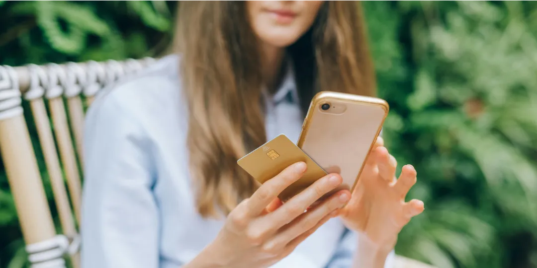 woman with phone and credit card